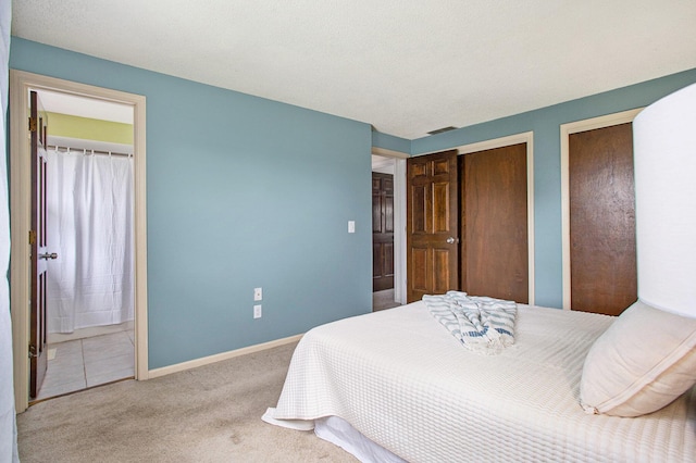 275 W State St, Coldwater, MI 49036 - carpeted bedroom featuring two closets and connected bathroom