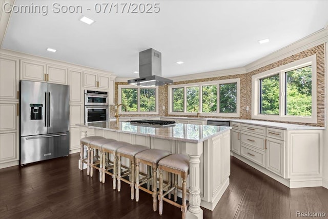 61353 W 8 Mile Rd, South Lyon, MI 48178 - kitchen with appliances with stainless steel finishes, island exhaust hood, light stone countertops, a kitchen island, and dark wood-type flooring