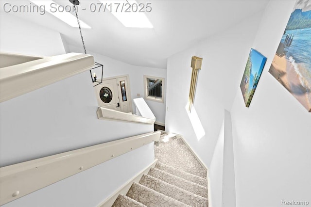 61353 W 8 Mile Rd, South Lyon, MI 48178 - stairway with vaulted ceiling and baseboards