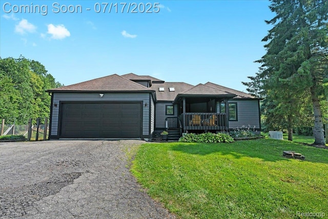 61353 W 8 Mile Rd, South Lyon, MI 48178 - view of front of house with asphalt driveway, a front lawn, an attached garage, and roof with shingles
