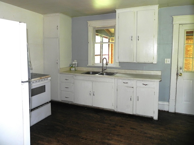 1111 S Main St, Three Rivers, MI 49093 - kitchen featuring white appliances, dark wood-type flooring, light countertops, and white cabinets