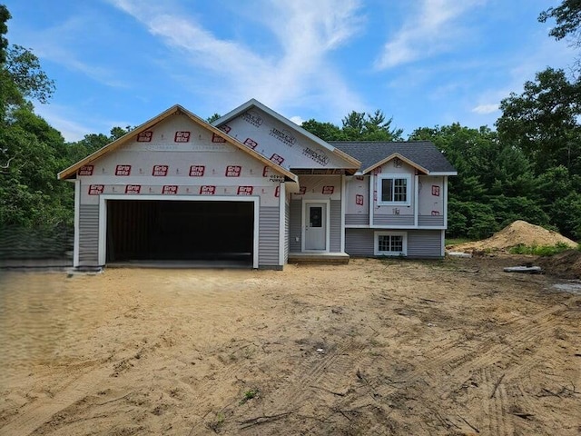 3746 Brickyard Rd, Holton, MI 49425 - view of front facade featuring an attached garage and dirt driveway