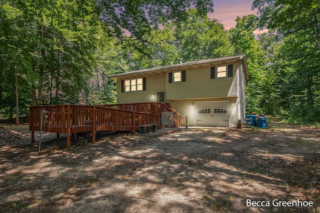 14180 168th Ave, Grand Haven, MI 49417 - rear view of property featuring a garage, a wooden deck, driveway, and stairway