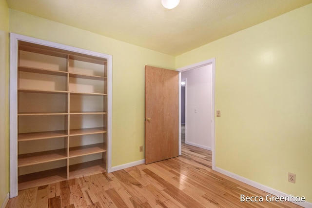14180 168th Ave, Grand Haven, MI 49417 - unfurnished bedroom with wood finished floors and a closet
