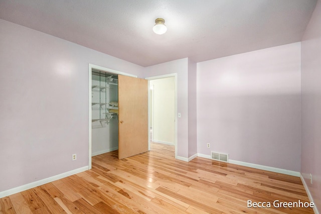 14180 168th Ave, Grand Haven, MI 49417 - unfurnished bedroom featuring wood finished floors