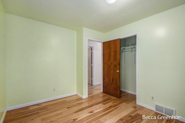 14180 168th Ave, Grand Haven, MI 49417 - unfurnished bedroom with light wood-style floors and a closet