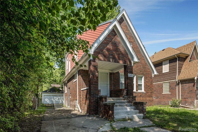 3921 Three Mile Dr, Detroit, MI 48224 - view of front of house with an outbuilding, brick siding, and a garage