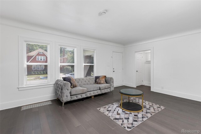 3921 Three Mile Dr, Detroit, MI 48224 - living area with baseboards and dark wood finished floors