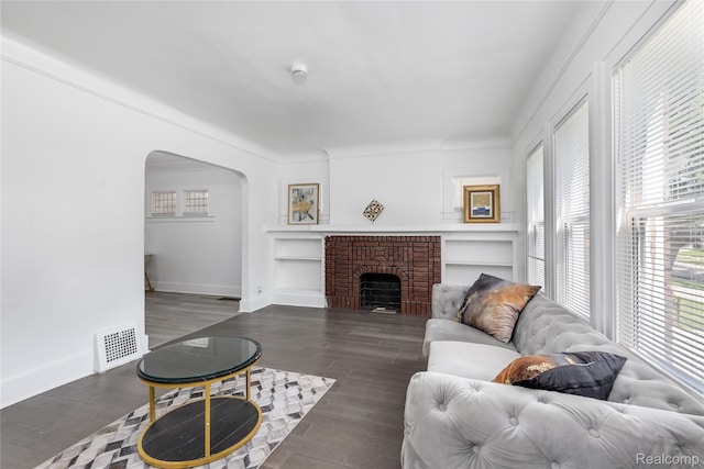 3921 Three Mile Dr, Detroit, MI 48224 - living area featuring arched walkways, dark wood-style floors, and built in features