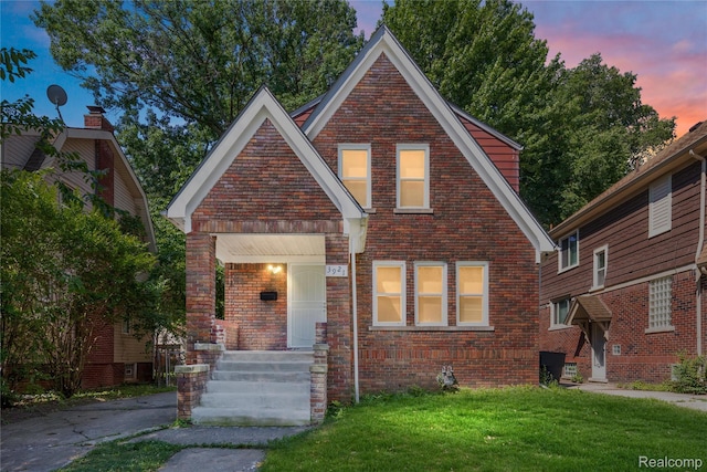 3921 Three Mile Dr, Detroit, MI 48224 - view of front facade featuring brick siding and a front lawn