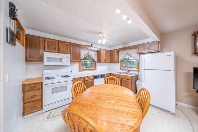 3110 13 Mile Rd, Remus, MI 49340 - kitchen with white appliances, light countertops, ceiling fan, and brown cabinets
