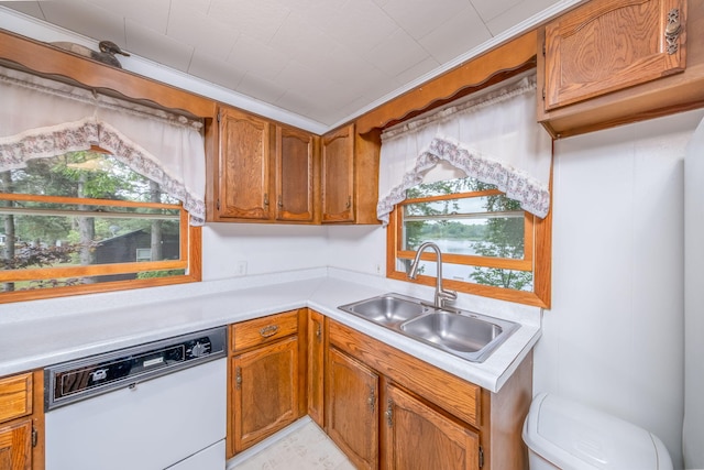 3110 13 Mile Rd, Remus, MI 49340 - kitchen featuring dishwasher, light countertops, and brown cabinetry