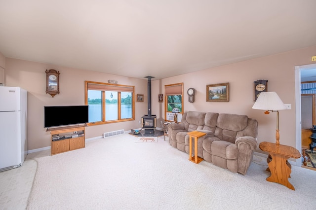 3110 13 Mile Rd, Remus, MI 49340 - carpeted living area with a wood stove and baseboards