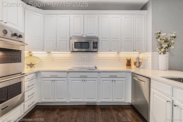 23331 Sawgrass Ct S, South Lyon, MI 48178 - kitchen with appliances with stainless steel finishes, light countertops, white cabinets, and backsplash