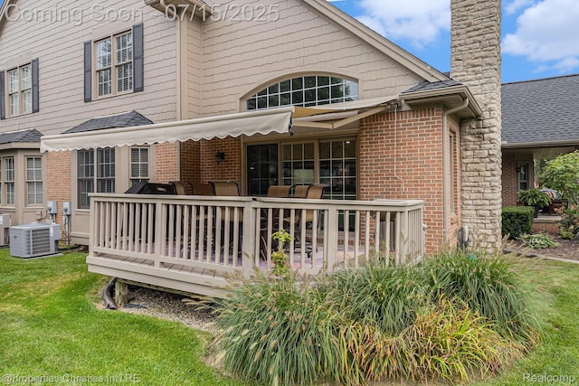 23331 Sawgrass Ct S, South Lyon, MI 48178 - back of property featuring brick siding, a wooden deck, a yard, and a chimney