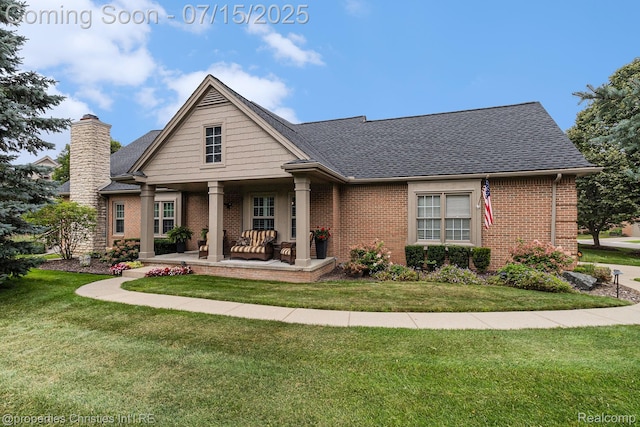 23331 Sawgrass Ct S, South Lyon, MI 48178 - view of front of property featuring brick siding, a front yard, a chimney, roof with shingles, and covered porch