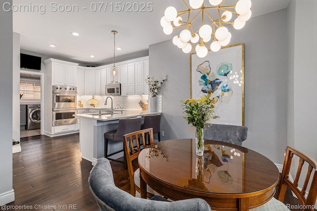 23331 Sawgrass Ct S, South Lyon, MI 48178 - dining room featuring dark wood-style flooring, washer / clothes dryer, a chandelier, and recessed lighting