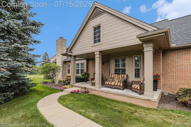 23331 Sawgrass Ct S, South Lyon, MI 48178 - view of front facade featuring a front lawn, brick siding, roof with shingles, a patio area, and an outdoor hangout area