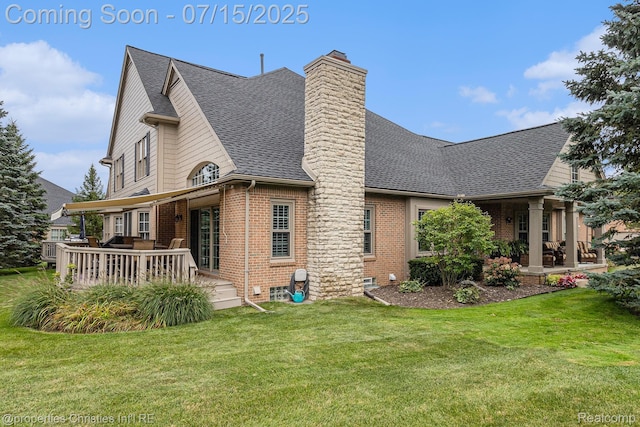 23331 Sawgrass Ct S, South Lyon, MI 48178 - back of house with brick siding, a yard, a chimney, roof with shingles, and a deck