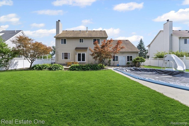 415 Evaline Dr, Troy, MI 48085 - rear view of house with a fenced backyard, a patio, and a chimney