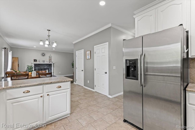 415 Evaline Dr, Troy, MI 48085 - kitchen featuring stainless steel refrigerator with ice dispenser, ornamental molding, white cabinetry, a fireplace, and a chandelier