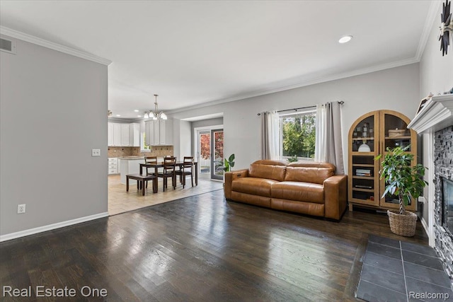 415 Evaline Dr, Troy, MI 48085 - living room with a fireplace with flush hearth, a chandelier, recessed lighting, dark wood-style floors, and ornamental molding