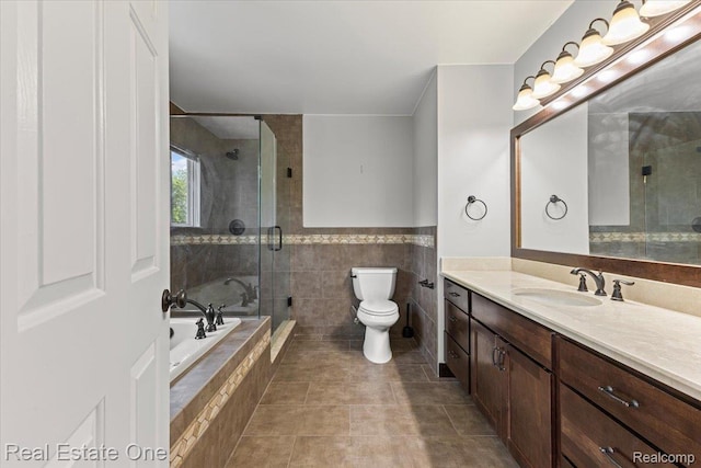 415 Evaline Dr, Troy, MI 48085 - full bathroom with vanity, a bath, tile walls, a shower stall, and tile patterned floors