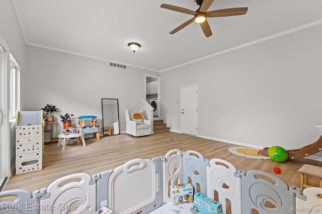 415 Evaline Dr, Troy, MI 48085 - bedroom featuring wood finished floors, crown molding, washer / dryer, and a ceiling fan