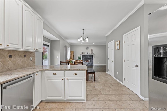 415 Evaline Dr, Troy, MI 48085 - kitchen with appliances with stainless steel finishes, white cabinets, a chandelier, decorative backsplash, and ornamental molding