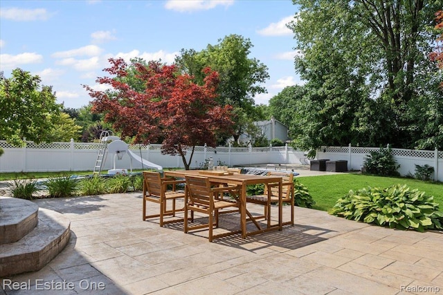 415 Evaline Dr, Troy, MI 48085 - fenced backyard featuring a patio and outdoor dining area
