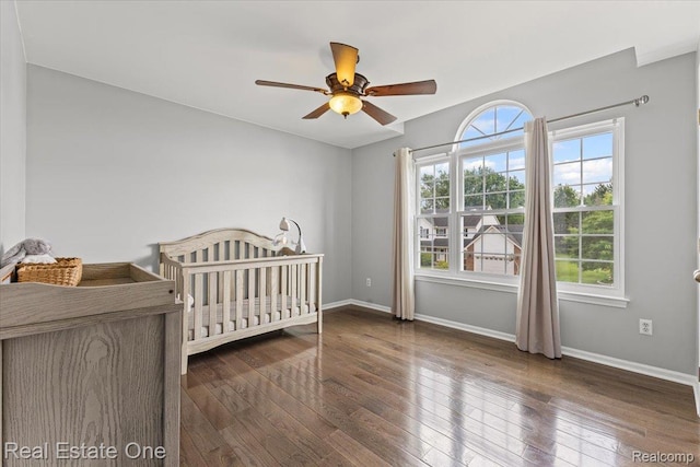 415 Evaline Dr, Troy, MI 48085 - bedroom featuring hardwood / wood-style floors, a ceiling fan, and a crib