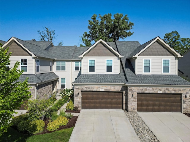 3064 N Spurway Dr, Ann Arbor, MI 48105 - craftsman inspired home featuring a garage, stone siding, concrete driveway, and a shingled roof