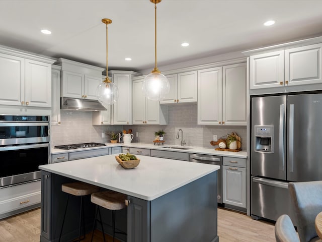 3064 N Spurway Dr, Ann Arbor, MI 48105 - kitchen with appliances with stainless steel finishes, a center island, light countertops, backsplash, and recessed lighting