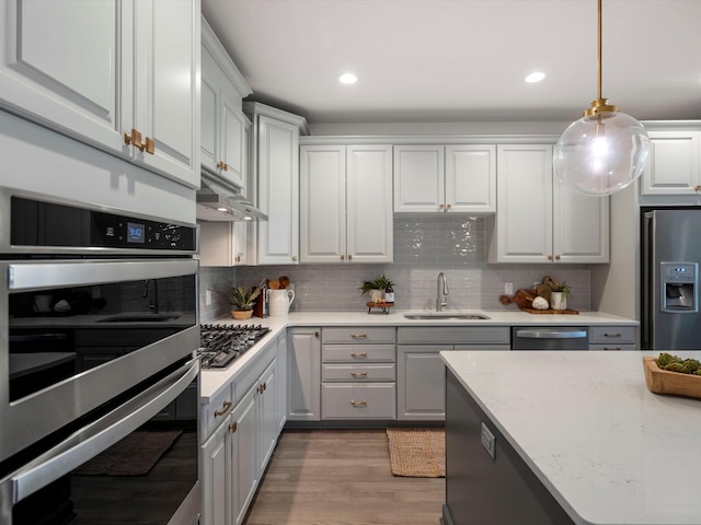 3064 N Spurway Dr, Ann Arbor, MI 48105 - kitchen with stainless steel appliances, gray cabinets, light wood finished floors, decorative backsplash, and recessed lighting