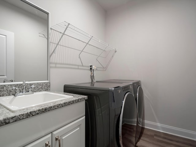 3064 N Spurway Dr, Ann Arbor, MI 48105 - laundry area featuring washing machine and clothes dryer, dark wood-style floors, and cabinet space