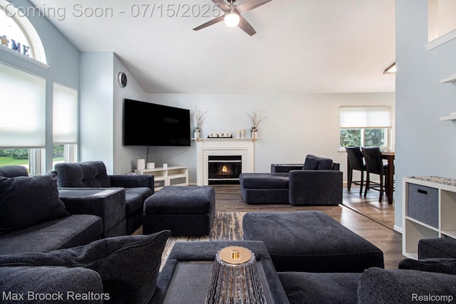 761 Stoney Dr, South Lyon, MI 48178 - living room with ceiling fan, wood finished floors, a brick fireplace, and vaulted ceiling