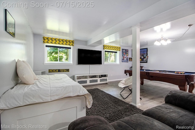 761 Stoney Dr, South Lyon, MI 48178 - bedroom featuring pool table, wood finished floors, and a chandelier