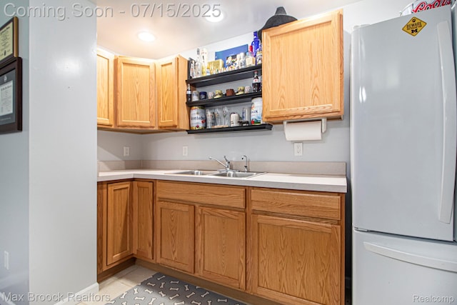 761 Stoney Dr, South Lyon, MI 48178 - kitchen featuring freestanding refrigerator, light tile patterned flooring, light countertops, and open shelves