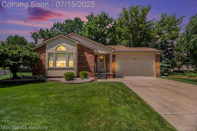 761 Stoney Dr, South Lyon, MI 48178 - view of front of property featuring brick siding, an attached garage, concrete driveway, and a chimney