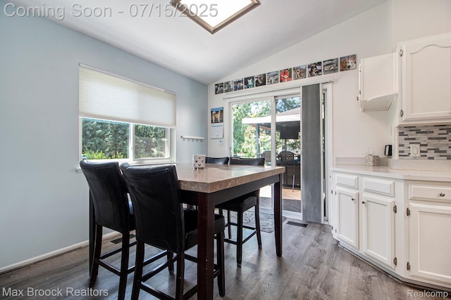 761 Stoney Dr, South Lyon, MI 48178 - dining area featuring vaulted ceiling and wood finished floors