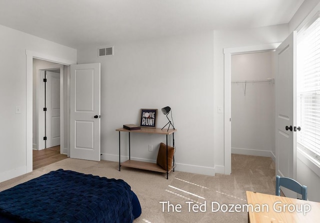 3171 Timberpine Ave, Holland, MI 49424 - carpeted bedroom featuring baseboards and a walk in closet