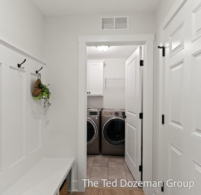 3171 Timberpine Ave, Holland, MI 49424 - laundry room featuring independent washer and dryer, light tile patterned floors, and cabinet space