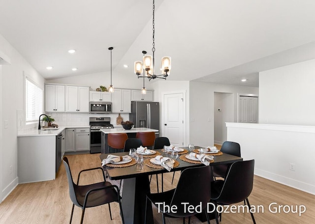 3171 Timberpine Ave, Holland, MI 49424 - dining area featuring light wood-style floors, a chandelier, recessed lighting, and lofted ceiling