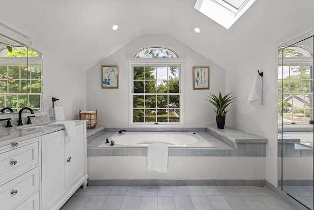 1618 Birmingham Blvd, Birmingham, MI 48009 - bathroom featuring a skylight, lofted ceiling, a bath, vanity, and tile patterned floors