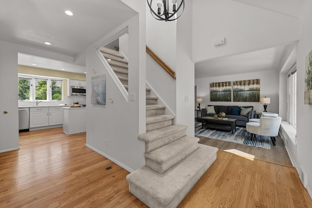 1618 Birmingham Blvd, Birmingham, MI 48009 - staircase with wood finished floors, recessed lighting, and a chandelier