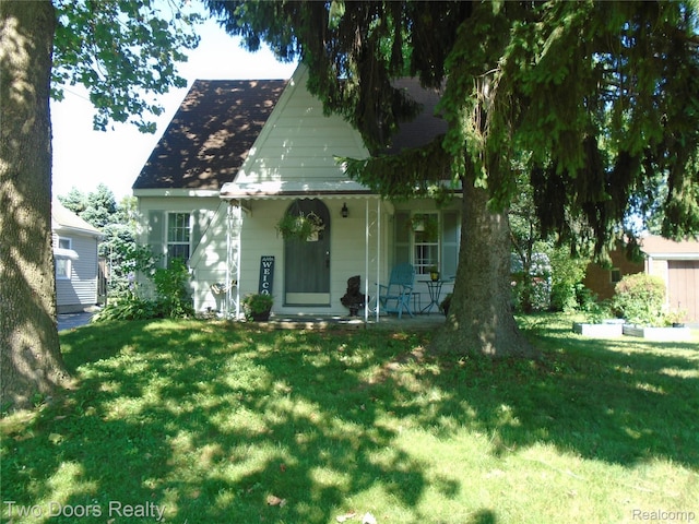 view of front of home with a porch and a front lawn