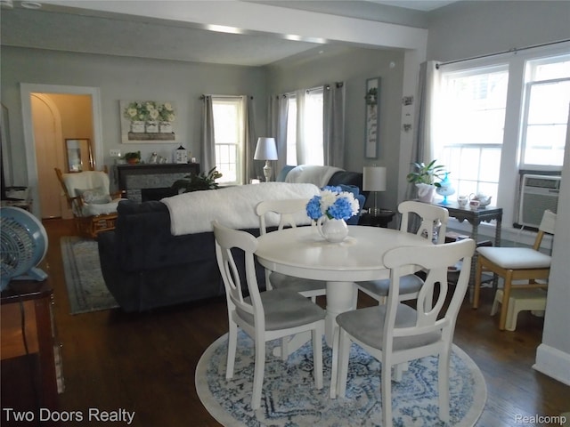 dining area featuring plenty of natural light, dark wood-style floors, and cooling unit