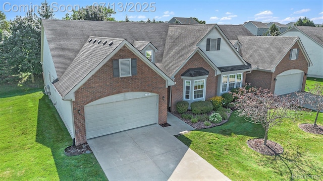7031 Iris Ct Unit 3, Grand Blanc, MI 48439 - view of front of property with brick siding, driveway, a front lawn, and roof with shingles