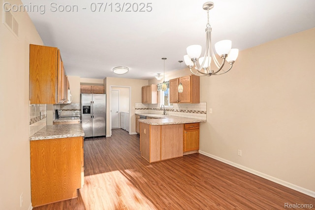 7031 Iris Ct Unit 3, Grand Blanc, MI 48439 - kitchen featuring stainless steel appliances, backsplash, and wood finished floors