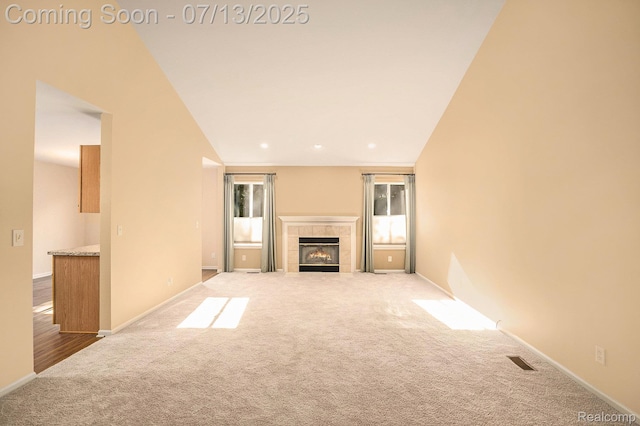 7031 Iris Ct Unit 3, Grand Blanc, MI 48439 - unfurnished living room with carpet flooring and a tile fireplace